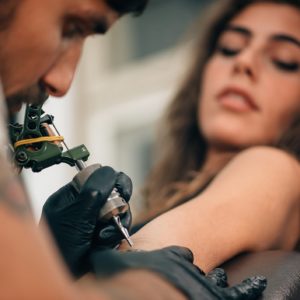 Woman being tattoo at training course