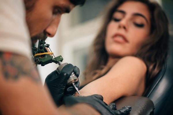 Woman being tattoo at training course